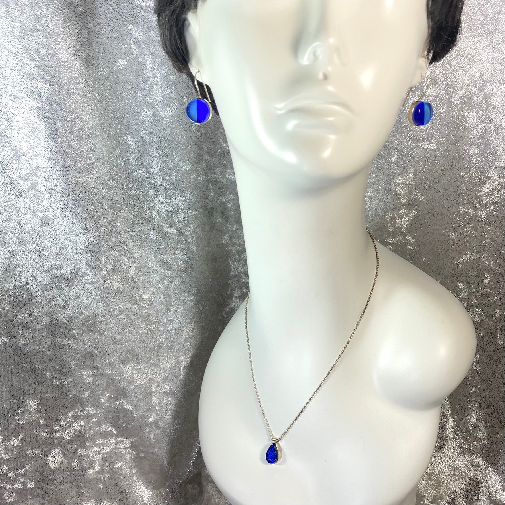 two tone circle earrings in light and dark blue,fused glass, glass jewelry, glass and silver jewelry, handmade, handcrafted, American Craft, hand fabricated jewelry, hand fabricated jewellery, Athen, Georgia, colorful jewelry, sparkle, bullseye glass, dichroic glass, art jewelry