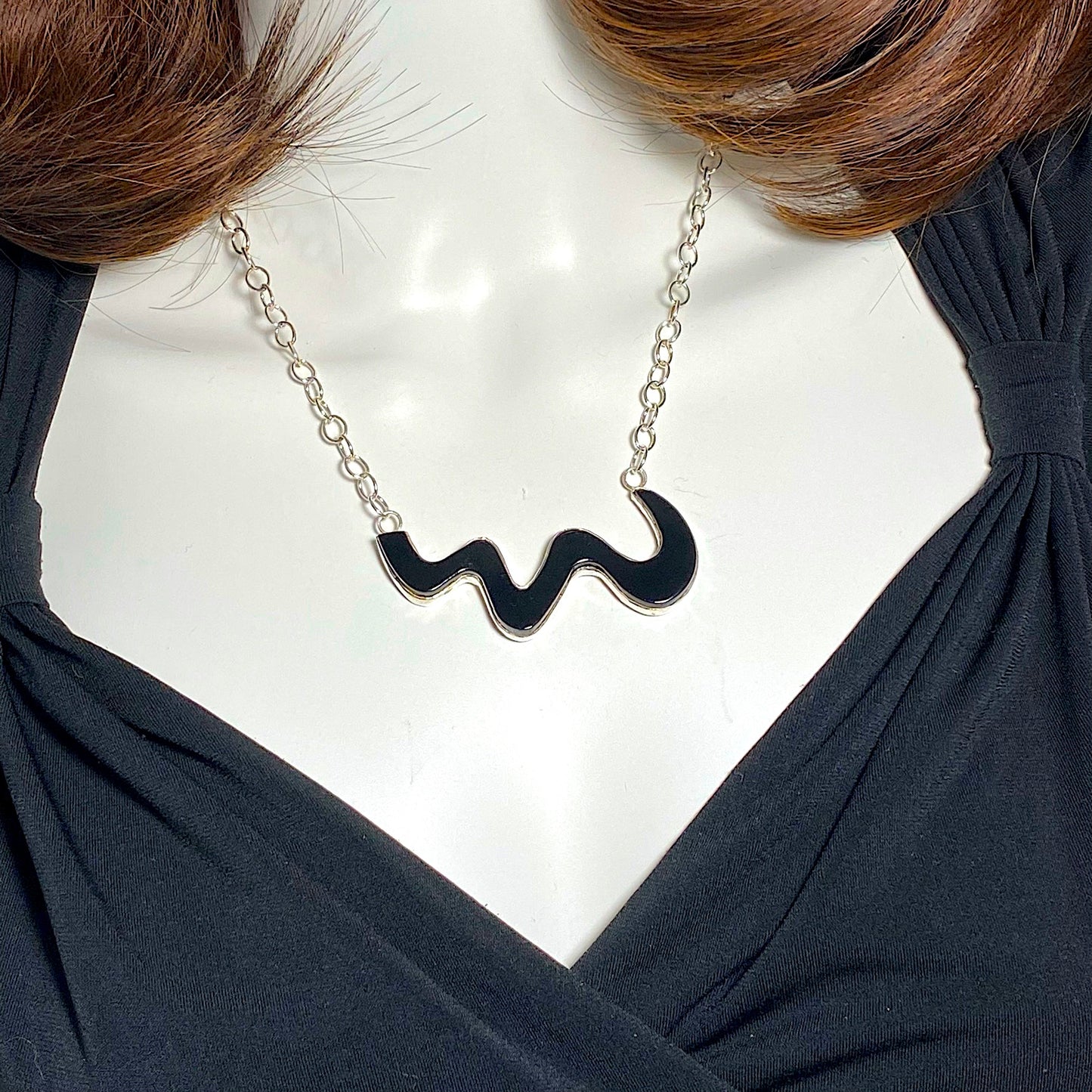 Black glass cut as a wave set in sterling silver, fused glass, glass jewelry, glass and silver jewelry, handmade, handcrafted, American Craft, hand fabricated jewelry, hand fabricated jewellery, Athen, Georgia, colorful jewelry, sparkle, bullseye glass, dichroic glass, art jewelry