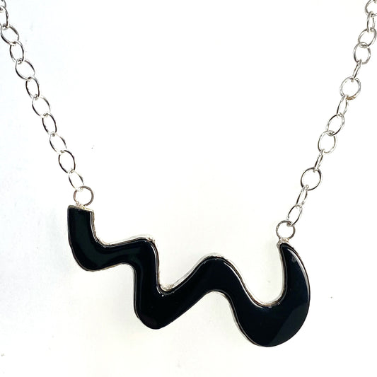 Black glass cut as a wave set in sterling silver, fused glass, glass jewelry, glass and silver jewelry, handmade, handcrafted, American Craft, hand fabricated jewelry, hand fabricated jewellery, Athen, Georgia, colorful jewelry, sparkle, bullseye glass, dichroic glass, art jewelry