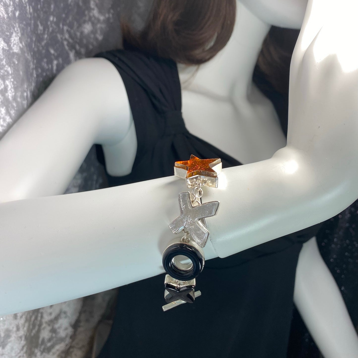 Statement bracelet in amber, white, black and silver glass in sterling silver, fused glass, glass jewelry, glass and silver jewelry, handmade, handcrafted, American Craft, hand fabricated jewelry, hand fabricated jewellery, Athen, Georgia, colorful jewelry, sparkle, bullseye glass, dichroic glass, art jewelry