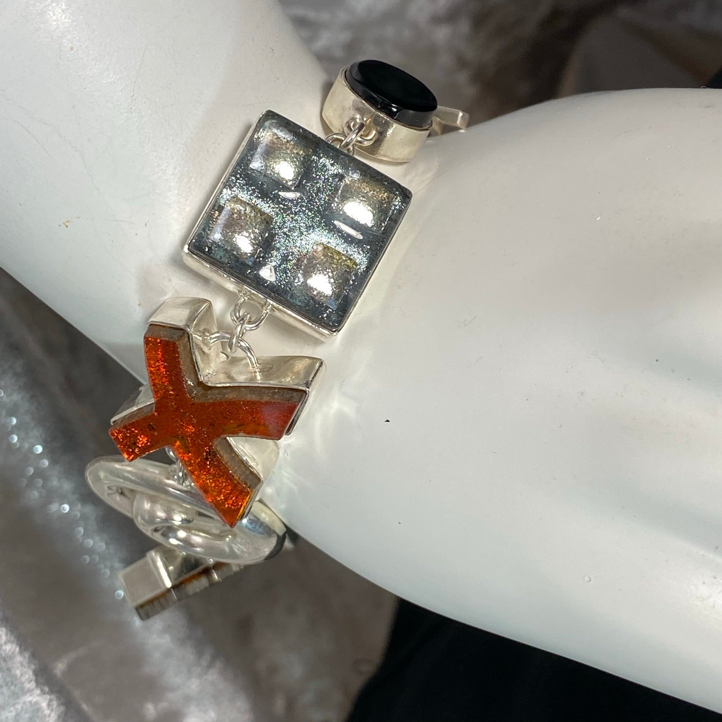 Statement bracelet in amber, white, black and silver glass in sterling silver, fused glass, glass jewelry, glass and silver jewelry, handmade, handcrafted, American Craft, hand fabricated jewelry, hand fabricated jewellery, Athen, Georgia, colorful jewelry, sparkle, bullseye glass, dichroic glass, art jewelry