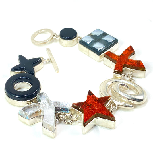 Statement bracelet in amber, white, black and silver glass in sterling silver, fused glass, glass jewelry, glass and silver jewelry, handmade, handcrafted, American Craft, hand fabricated jewelry, hand fabricated jewellery, Athen, Georgia, colorful jewelry, sparkle, bullseye glass, dichroic glass, art jewelry