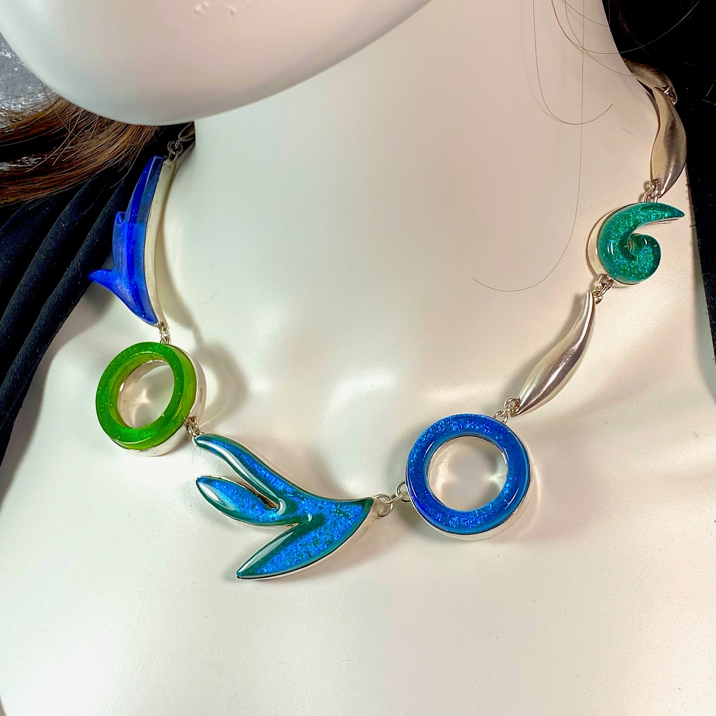 Statement necklace in turquoise, green, teal, azure colored glass in sterling silver, fused glass, glass jewelry, glass and silver jewelry, handmade, handcrafted, American Craft, hand fabricated jewelry, hand fabricated jewellery, Athen, Georgia, colorful jewelry, sparkle, bullseye glass, dichroic glass, art jewelry