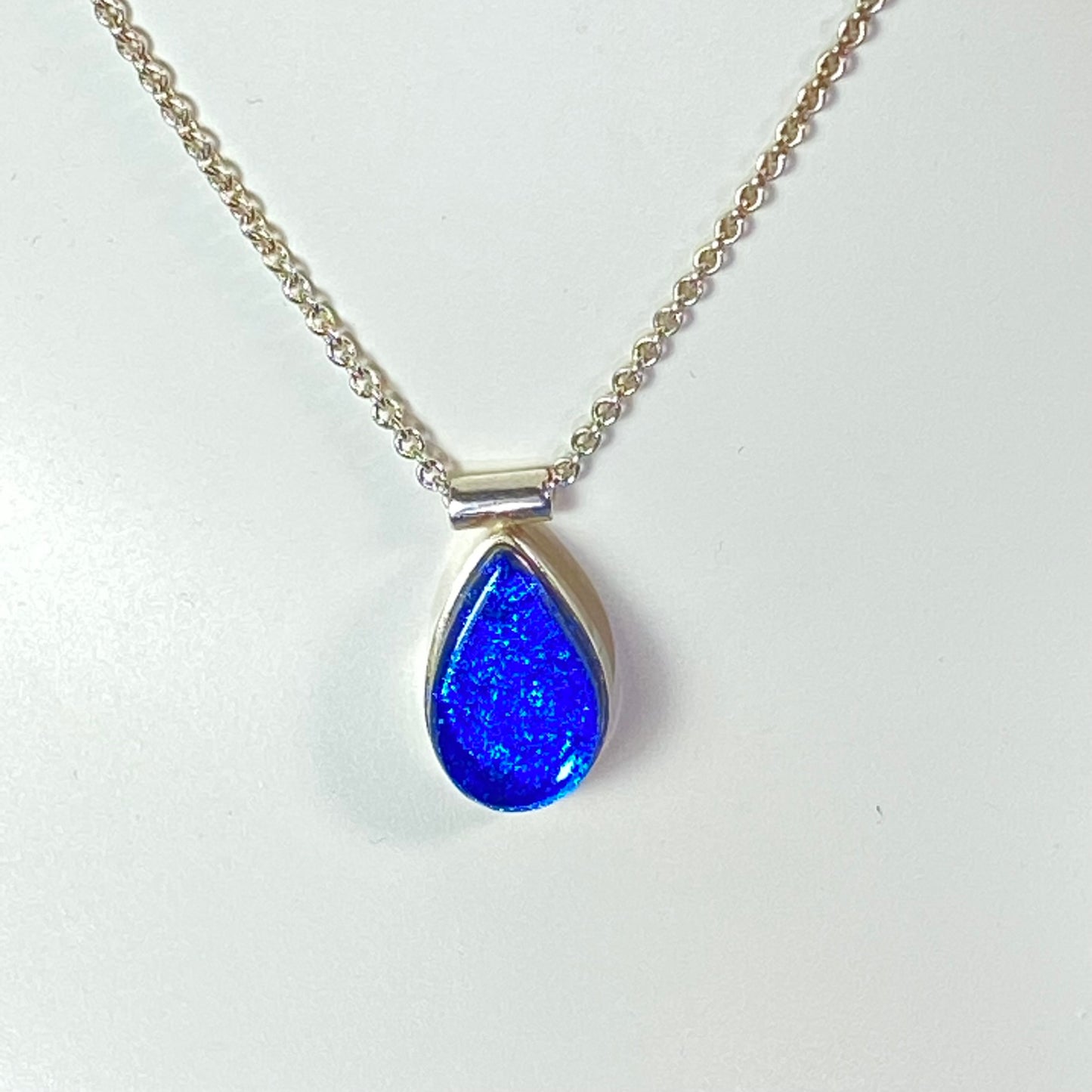 Teardrop peacock blue glass small necklace, sterling silver cable chain, glass jewelry, glass and silver jewelry, handmade, handcrafted, American Craft, hand fabricated jewelry, hand fabricated jewellery, Athen, Georgia, colorful jewelry, sparkle, bullseye glass, dichroic glass, art jewelry
