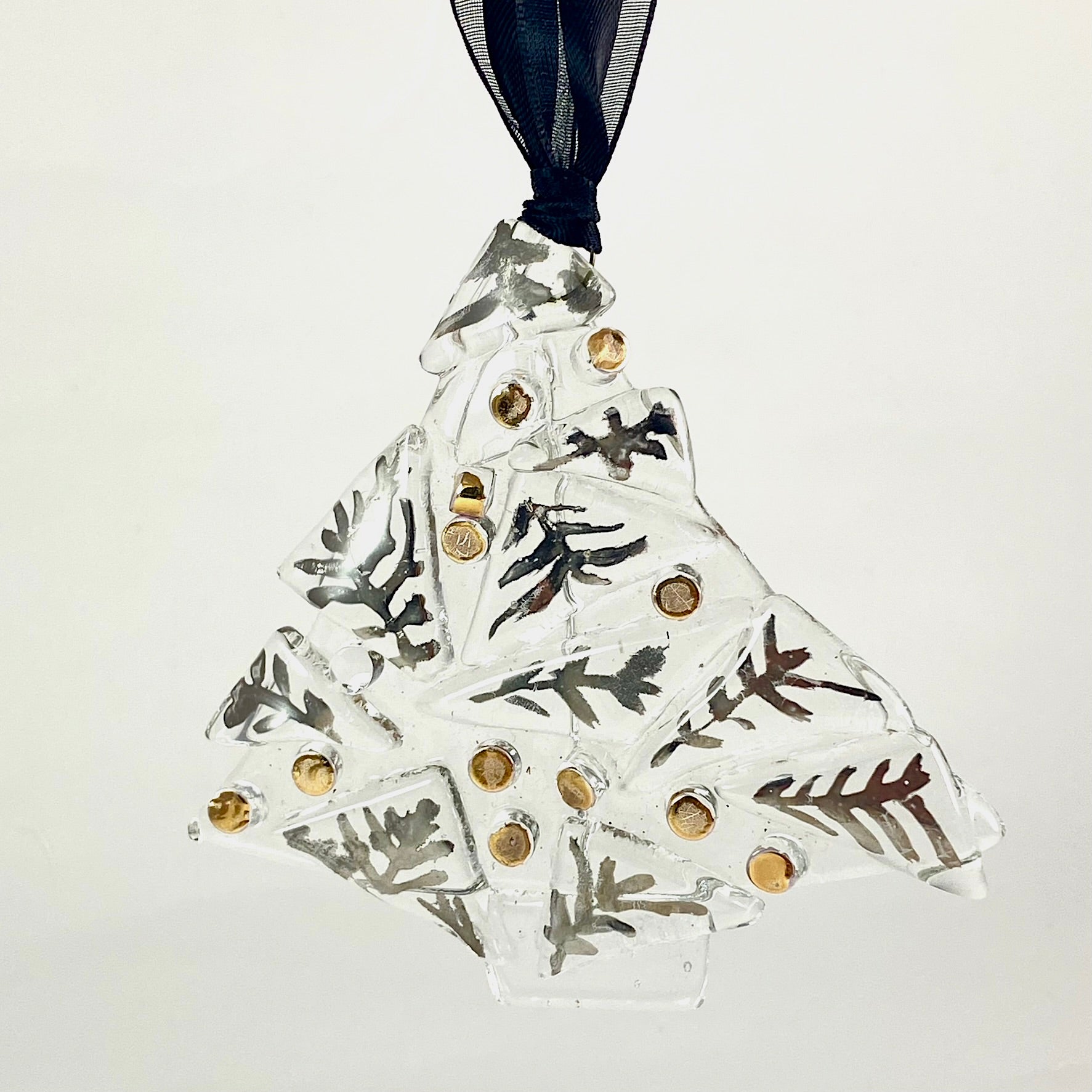single 3 1/2 inches wide by 3 1/4 inch tall abstract clear tree ornament with silver luster leaves and gold luster balls fired on