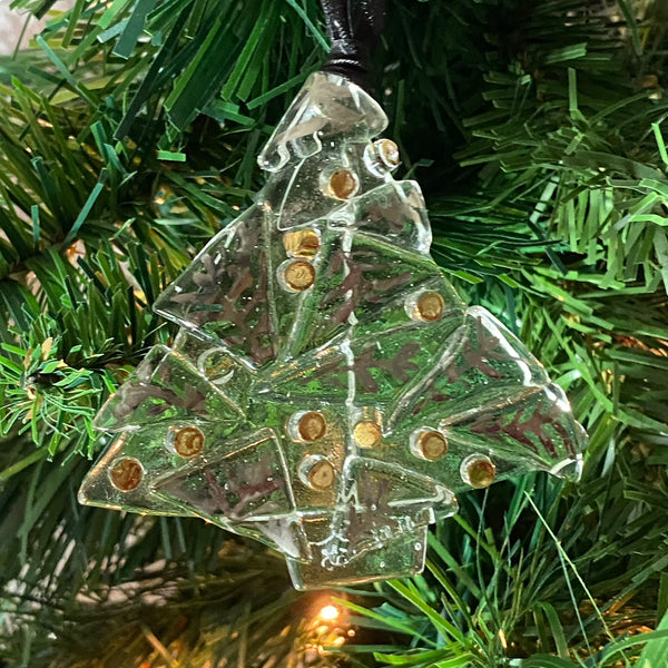 shown in christmas tree is a single 3 1/2 inches wide by 3 1/4 inch tall abstract clear tree ornament with silver luster leaves and gold luster balls fired on