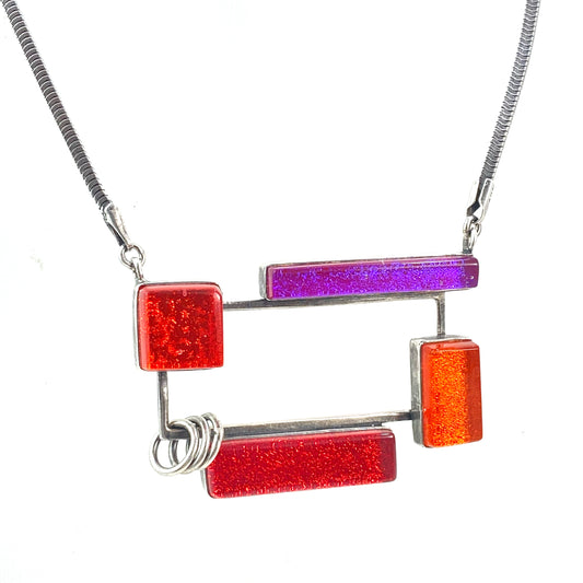 open rectangle necklace, mid century modern inspired, red, orange and pink, fused glass, glass jewelry, glass and silver jewelry, handmade, handcrafted, American Craft, hand fabricated jewelry, hand fabricated jewellery, Athen, Georgia, colorful jewelry, sparkle, bullseye glass, dichroic glass, art jewelry