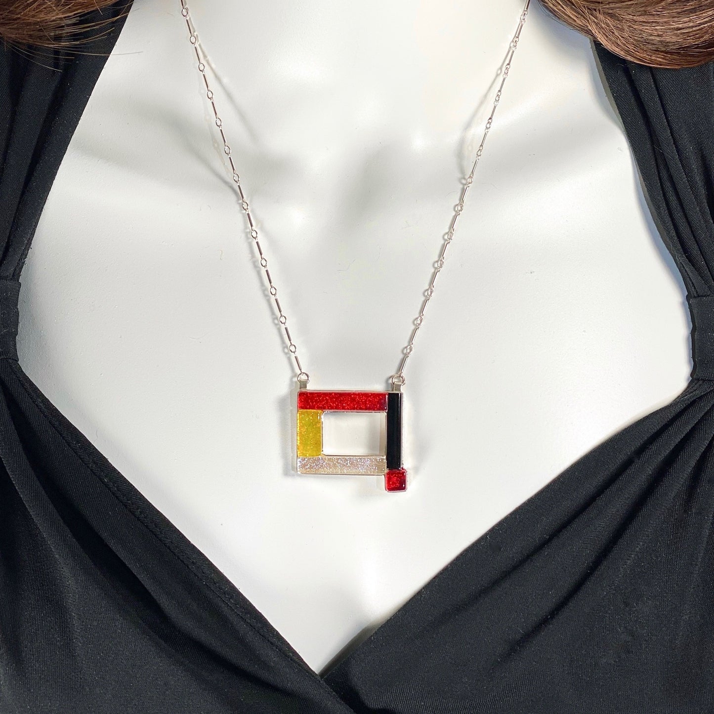open rectangle necklace, mid century modern inspired, red, yellow, black and white, fused glass, glass jewelry, glass and silver jewelry, handmade, handcrafted, American Craft, hand fabricated jewelry, hand fabricated jewellery, Athen, Georgia, colorful jewelry, sparkle, bullseye glass, dichroic glass, art jewelry