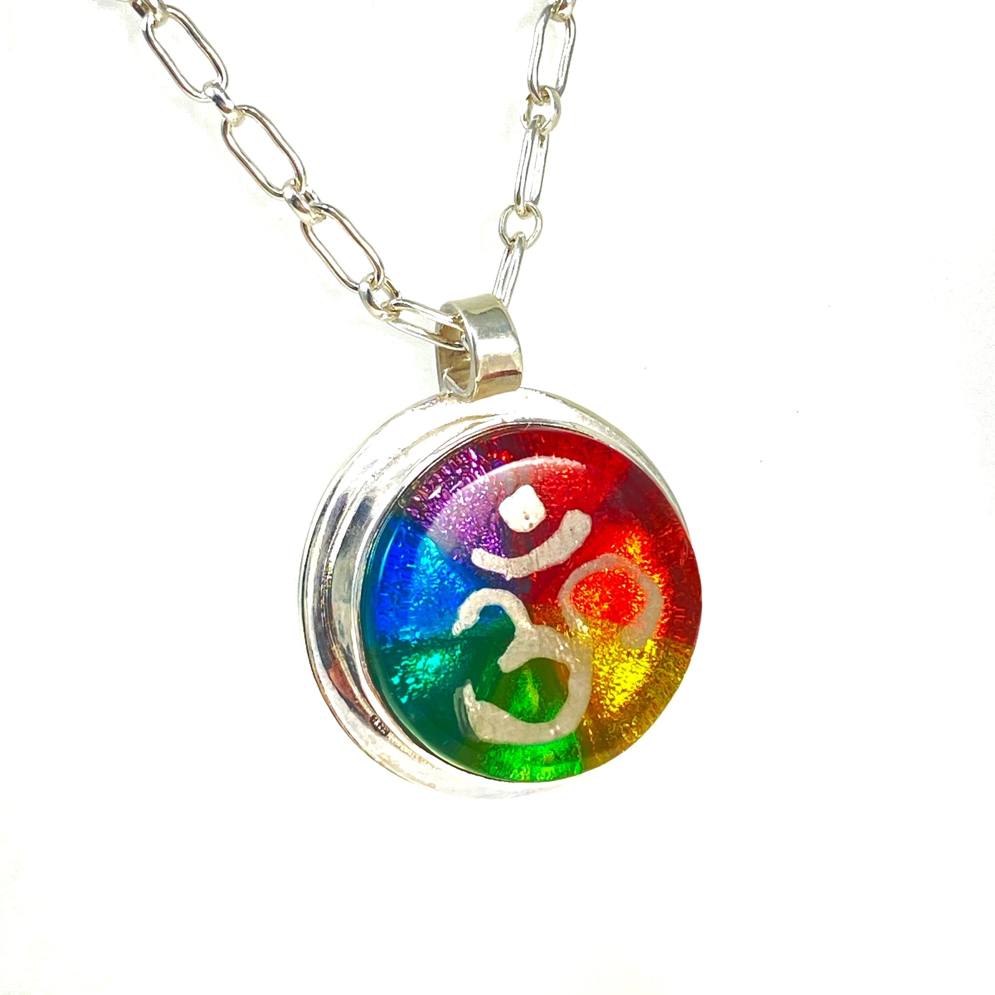kaleidoscope circle necklace in rainbow colors, silver luster painted OHM symbol,fused glass, glass jewelry, glass and silver jewelry, handmade, handcrafted, American Craft, hand fabricated jewelry, hand fabricated jewellery, Athen, Georgia, colorful jewelry, sparkle, bullseye glass, dichroic glass, art jewelry